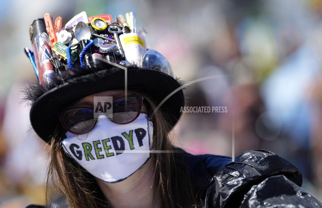 Alastair Grant A protestor wears a protective facemask with message during a demonstration around the meeting of the G7 in Falmouth, Cornwall, England, Saturday, June 12, 2021. Leaders of the G7 gather for a second day of meetings on Saturday, in which they will discuss COVID-19, climate, foreign policy and the economy. (AP Photo/Alastair Grant)