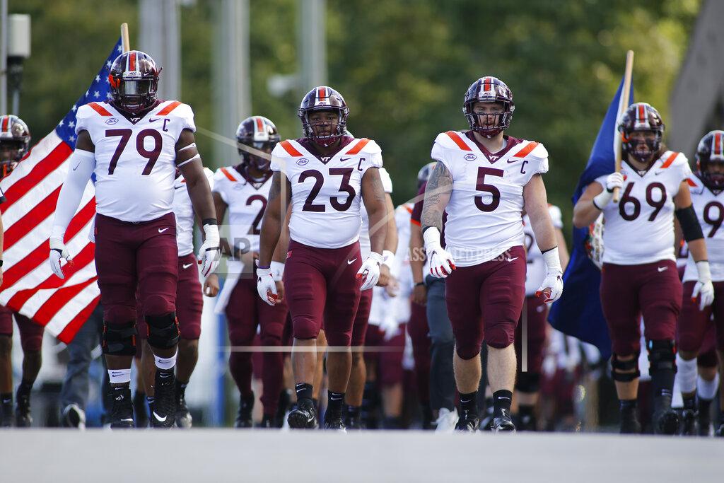 Nell Redmond Led by offensive lineman Tyrell Smith (79) and linebacker Rayshard Ashby (23) and defensive lineman Jarrod Hewitt, the Virginia Tech walks onto the field to play Duke in an NCAA college football game, Saturday, Oct. 3, 2020, in Durham, N.C. (Nell Redmond/Pool Photo via AP)
