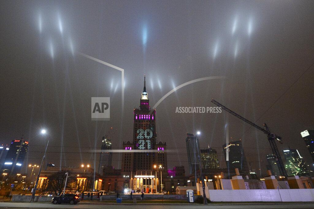 Czarek Sokolowski Light beams instead of traditional fireworks are seen around Warsaw's tallest building, The Palace of Culture and Science, greeted New Year under anti-COVID-19 restrictions in downtown Warsaw, Poland, Friday, Jan. 1, 2021.(AP Photo/Czarek Sokolowski)