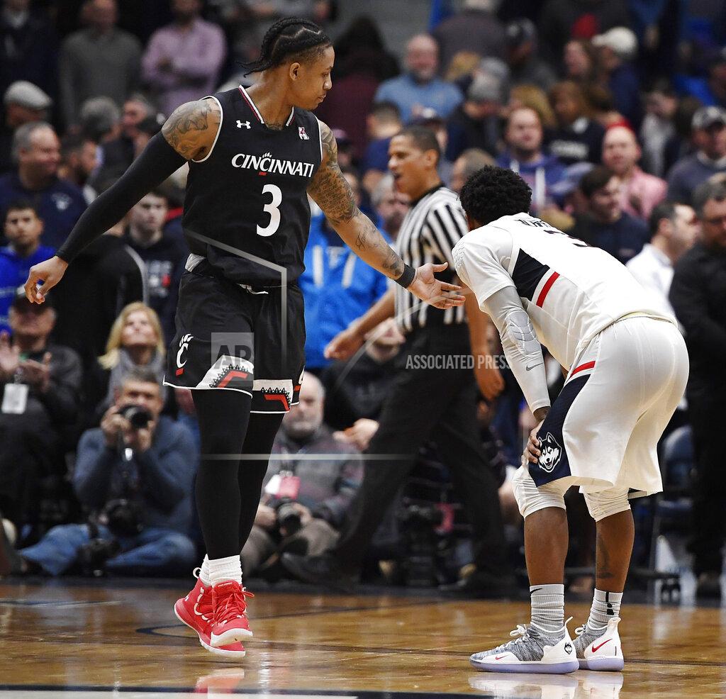 Jessica Hill Cincinnati's Justin Jenifer reaches out to Connecticut's Alterique Gilbert (3) after Gilbert missed a shot at the end of an NCAA college basketball game, Sunday, Feb. 24, 2019, in Hartford, Conn. (AP Photo/Jessica Hill)