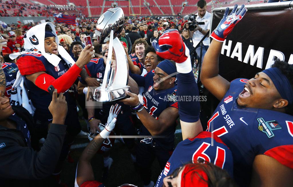 John Locher Fresno State players celebrate with the trophy after defeating Arizona State in the Las Vegas Bowl NCAA college football game, Saturday, Dec. 15, 2018, in Las Vegas. Fresno State won 31-20. (AP Photo/John Locher)