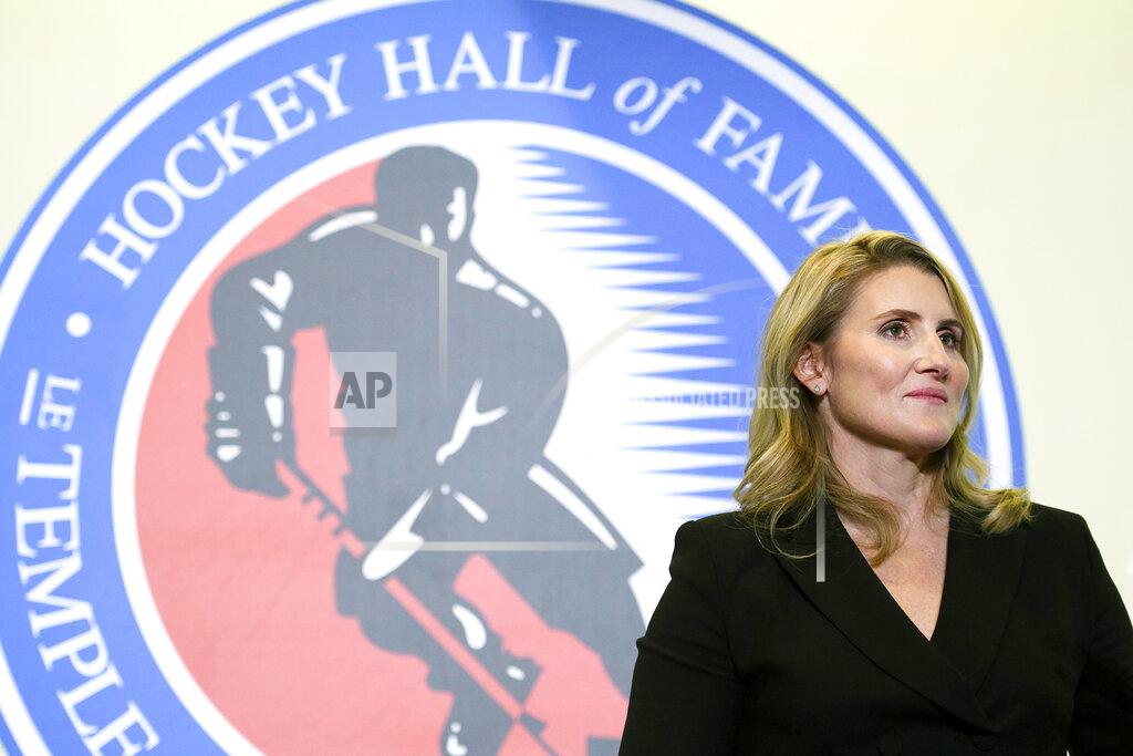 Nathan Denette FILE - In this Nov. 15, 2019, file photo, Hockey Hall of Fame inductee Hayley Wickenheiser poses in Toronto. Regional Olympic officials are rallying around the IOC and have backed its stance on opening the Tokyo Games as scheduled. Their support comes one day after direct criticism from athletes amid the coronavirus outbreak. “I think the IOC insisting this will move ahead, with such conviction, is insensitive and irresponsible given the state of humanity,” said Wickenheiser, a four-time Olympic hockey gold medalist from Canada. (Nathan Denette/The Canadian Press via AP, Fle)