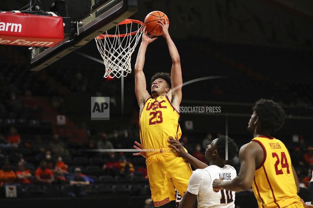 Amanda Loman Southern California forward Max Agbonkpolo drives to the basket past Oregon State forward Warith Alatishe during the second half of an NCAA college basketball game Thursday, Feb. 24, 2022, in Corvallis, Ore. Southern California won 94-91. (AP Photo/Amanda Loman)