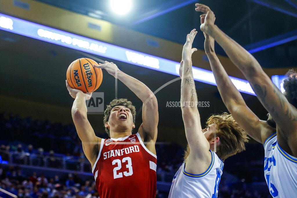 Ringo H.w. Chiu Stanford forward Brandon Angel (23) shoots under pressure from UCLA guard Jake Kyman (13) and center Myles Johnson (15) in the first half of an NCAA college basketball game Saturday, Jan. 29, 2022, in Los Angeles. (AP Photo/Ringo H.W. Chiu)