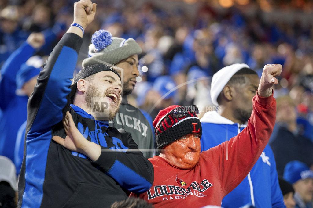 Bryan Woolston Kyle Wathen, left, and his father-in-law, John Arnold, right, cheer and jeer during the first half of the NCAA college football game between Louisville and Kentucky in Louisville, Ky., Saturday, Nov. 24, 2018. (AP Photo/Bryan Woolston)
