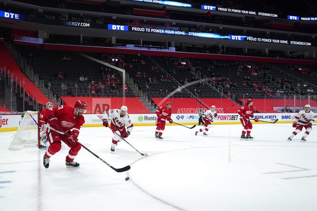Paul Sancya Detroit Red Wings defenseman Patrik Nemeth (22) clears the puck against the Carolina Hurricanes in front of a small crowd of family and friends at Little Caesars Arena in the first period of an NHL hockey game Thursday, Jan. 14, 2021, in Detroit. (AP Photo/Paul Sancya)