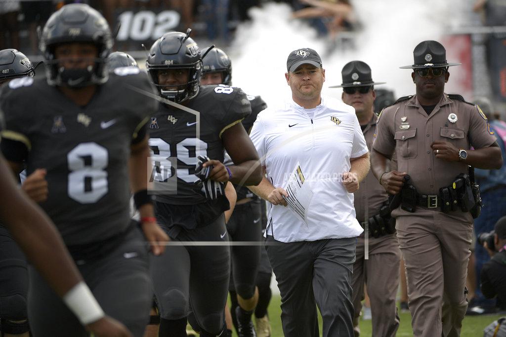 FILE - In this Saturday, Nov. 10, 2018, file photo, Central Florida head coach Josh Heupel, center, runs onto the field with the team before an NCAA college football game against Navy in Orlando, Fla. UCF and Cincinnati are Top 25 teams eager to show college football fans what they and the American Athletic Conference are all about. The undefeated, 11th-ranked Knights and once-beaten No. 19 Cincinnati take a shot at stating their case this week in a primetime, nationally televised matchup with league championship implications.
(AP Photo/Phelan M. Ebenhack, File)