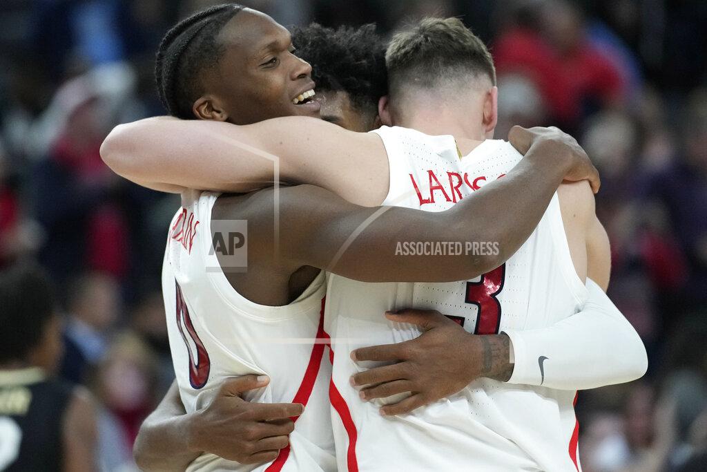 John Locher From left, Arizona's Bennedict Mathurin (0), Justin Kier (5) and Pelle Larsson (3) embrace after defeating Colorado in an NCAA college basketball game in the semifinal round of the Pac-12 tournament Friday, March 11, 2022, in Las Vegas. (AP Photo/John Locher)