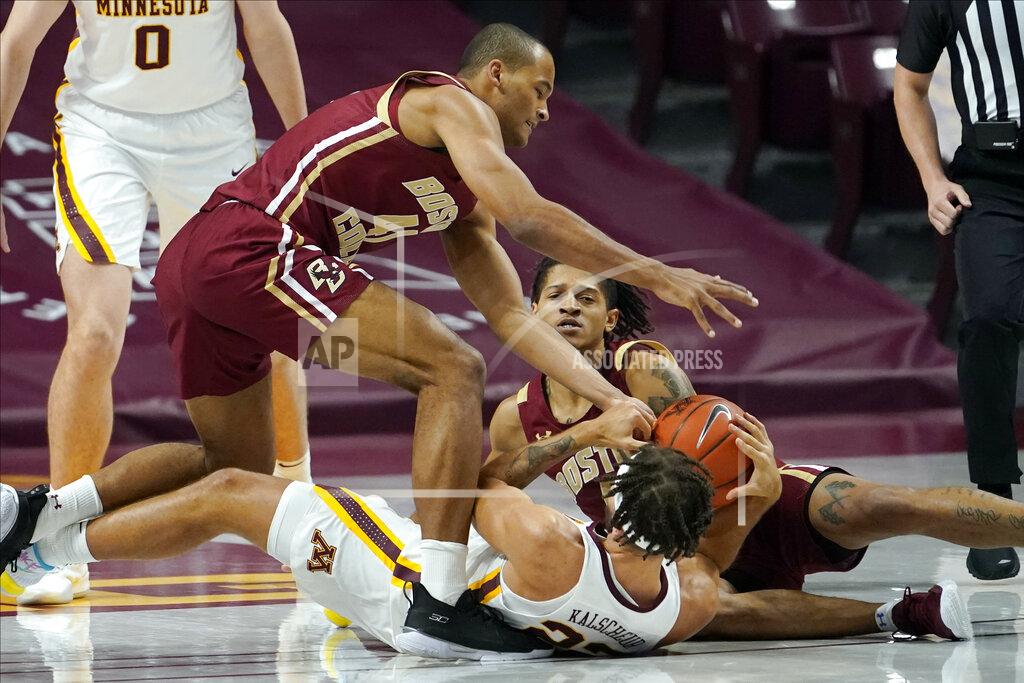 Jim Mone Boston College's Steffon Mitchell, left, and Makai Ashton-Langford scramble for the ball with Minnesota's Gabe Kalscheur, bottom center, during the first half of an NCAA college basketball game Tuesday, Dec. 8, 2020, in Minneapolis. (AP Photo/Jim Mone)