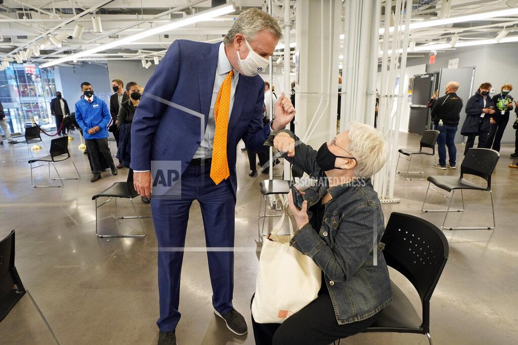 Richard Drew New York Mayor Bill de Blasio, bumps elbows with a woman after she was vaccinated, following his tour of the grand opening of a Broadway COVID-19 vaccination site intended to jump-start the city's entertainment industry, in New York, Monday, April 12, 2021. (AP Photo/Richard Drew, Pool)