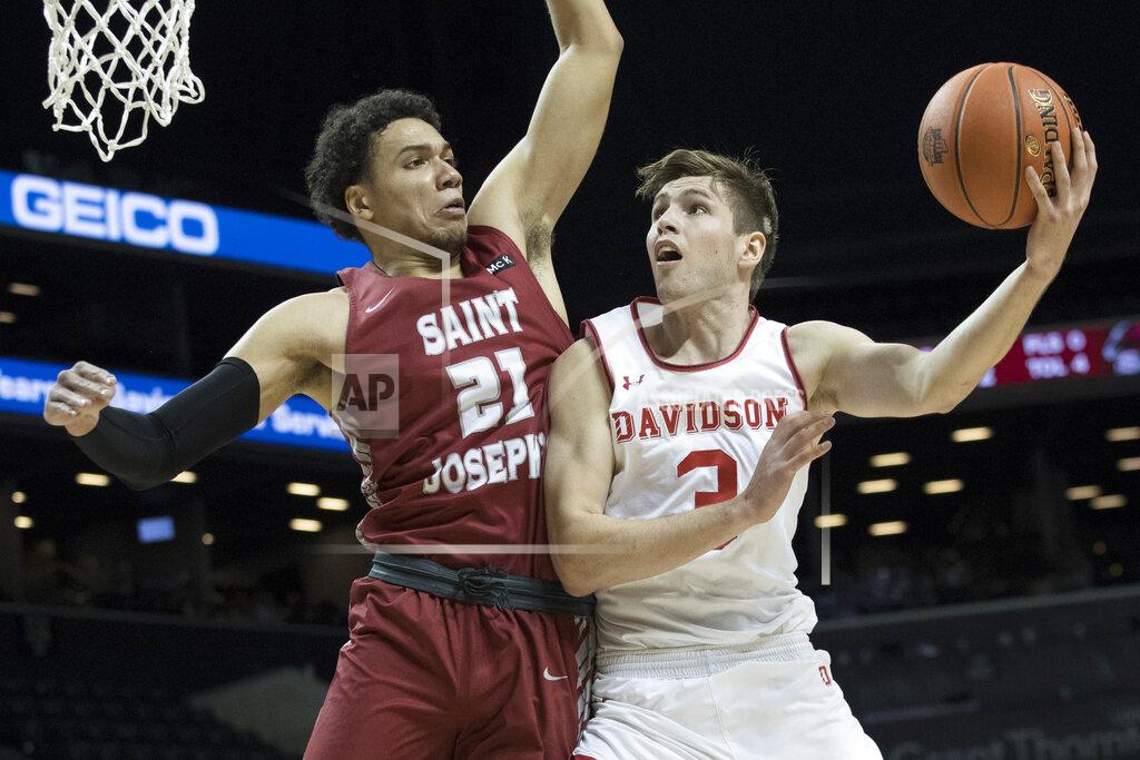 Mary Altaffer Davidson guard Jon Axel Gudmundsson (3) goes to the basket against Saint Joseph's forward Lorenzo Edwards (21) during the first half of an NCAA college basketball game in the Atlantic 10 Conference tournament, Friday, March 15, 2019, in New York. (AP Photo/Mary Altaffer)