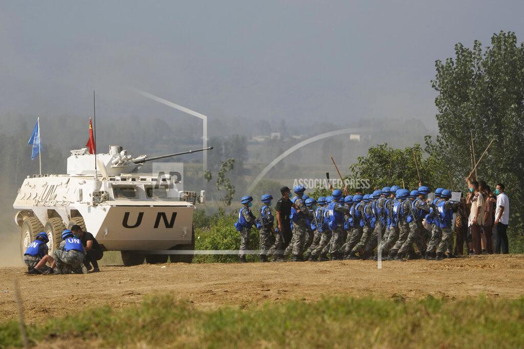 Ng Han Guan United Nations troops break up fighting in a scenario where participants playing the role of civilians fighting over water resource during the Shared Destiny 2021 drill at the Queshan Peacekeeping Operation training base in Queshan County in central China's Henan province Wednesday, Sept. 15, 2021. Peacekeeping troops from China, Thailand, Mongolia and Pakistan took part in the 10 days long exercise that field reconnaissance, armed escort, response to terrorist attacks, medical evacuation and epidemic control. (AP Photo/Ng Han Guan)