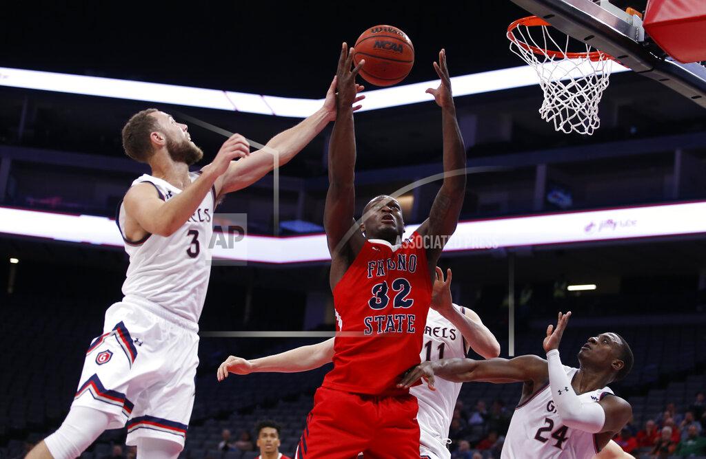 Rich Pedroncelli Fresno State forward Nate Grimes, center, goes for the rebound between Saint Mary's Jordan Ford, left, Matthias Tass, back, and Malik Fitts, right, during the second half of an NCAA college basketball game in Sacramento, Calif., Wednesday, Nov. 20, 2019. Saint Mary's won 68-58.(AP Photo/Rich Pedroncelli)