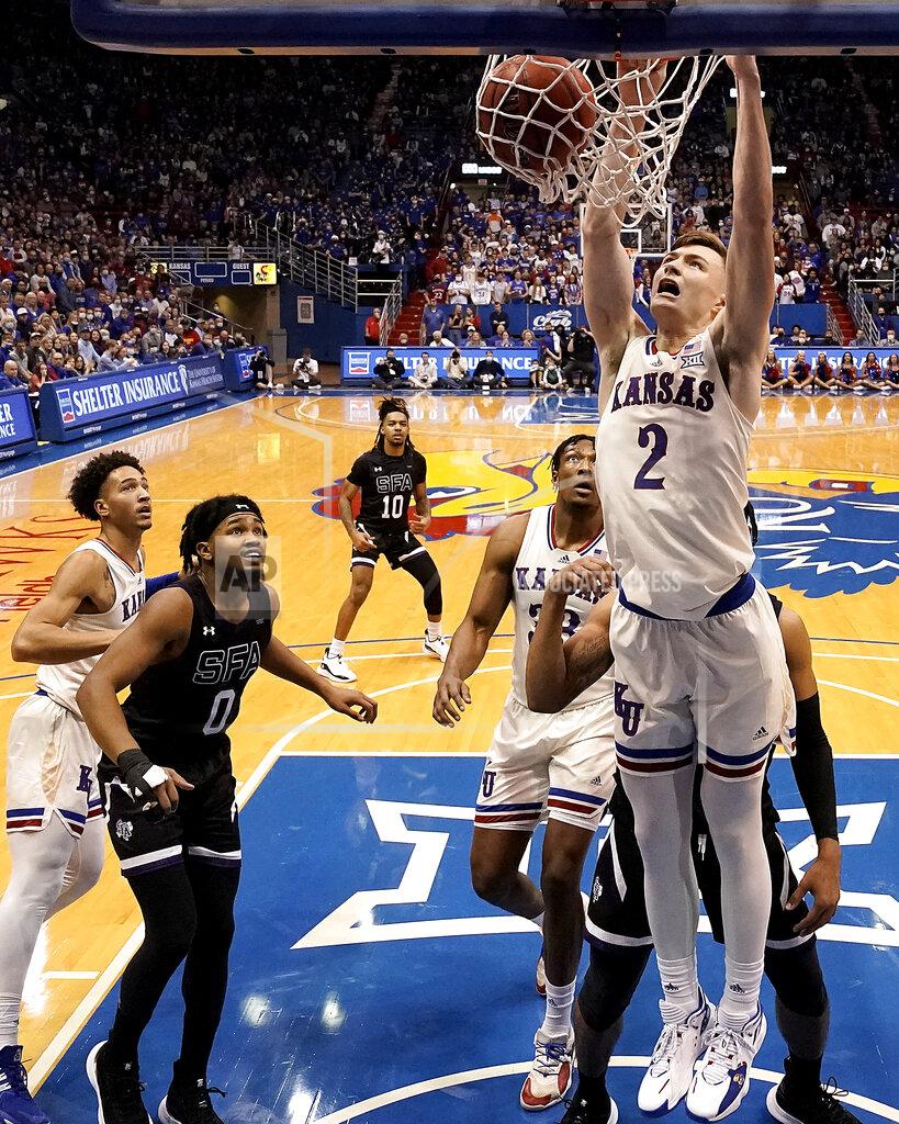 Charlie Riedel Kansas' Christian Braun (2) dunks the ball during the second half of an NCAA college basketball game against Stephen F. Austin Saturday, Dec. 18, 2021, in Lawrence, Kan. (AP Photo/Charlie Riedel)