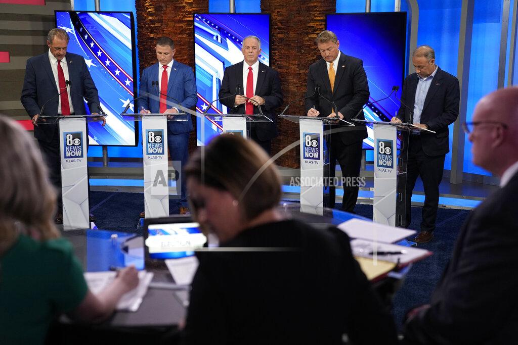 John Locher From left, North Las Vegas Mayor John Lee, Joey Gilbert, Clark County Sheriff Joe Lombardo, former U.S. Senator Dean Heller and Guy Nohra stand before a Republican primary debate for Nevada governor Wednesday, May 25, 2022, in Las Vegas. (AP Photo/John Locher, Pool)