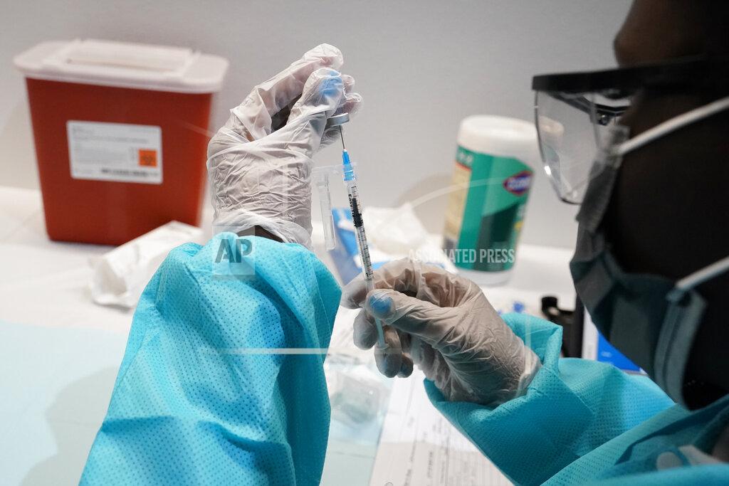 Mary Altaffer FILE - In this July 22, 2021 file photo, a health care worker fills a syringe with the Pfizer COVID-19 vaccine at the American Museum of Natural History in New York. Most Americans who haven’t been vaccinated against COVID-19 say they are unlikely to get the shots and doubt they would work against the aggressive delta variant despite evidence they do, according to a new poll that underscores the challenges facing public health officials amid soaring infections in some states.(AP Photo/Mary Altaffer)