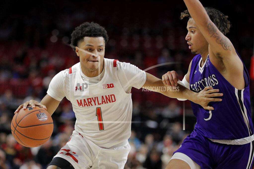 Julio Cortez Maryland guard Anthony Cowan Jr. (1) drives against Holy Cross guard Drew Lowder (3) during the first half of an NCAA college basketball game, Tuesday, Nov. 5, 2019, in College Park, Md. (AP Photo/Julio Cortez)