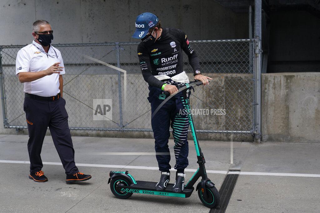 Darron Cummings Gil de Ferran, left, talks with Fernando Alonso, of Spain, as the go back to the garage during a practice session for the Indianapolis 500 auto race at Indianapolis Motor Speedway, Thursday, Aug. 13, 2020, in Indianapolis. (AP Photo/Darron Cummings)