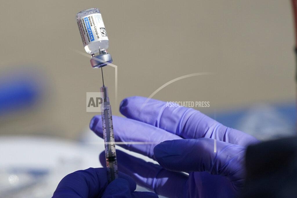 Orlin Wagner A nurse fills a syringe with COVID-19 vaccine at a mass vaccination site in Kansas City, Mo., Friday, March 19, 2021. (AP Photo/Orlin Wagner)