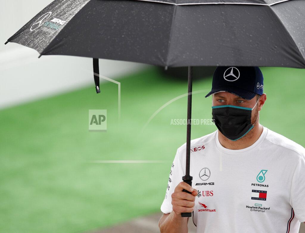 Mercedes driver Valtteri Bottas of Finland arrives at the paddocks for preparations before the practice session prior to the Formula One Grand Prix at the Barcelona Catalunya racetrack in Montmelo, Spain, Friday, Aug. 14, 2020. (Alejandro Garcia, Pool via AP)