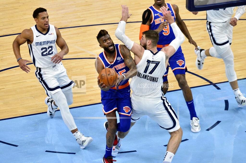 Brandon Dill New York Knicks forward Reggie Bullock handles the ball against Memphis Grizzlies center Jonas Valanciunas (17) in the second half of an NBA basketball game Monday, May 3, 2021, in Memphis, Tenn. (AP Photo/Brandon Dill)