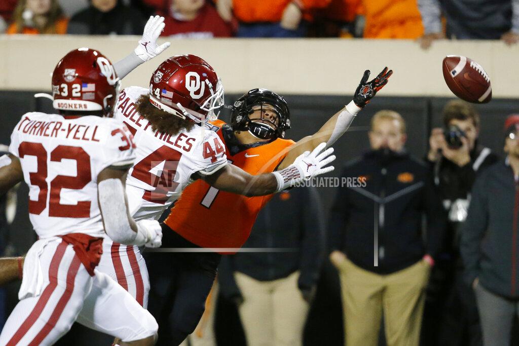 Sue Ogrocki Oklahoma State wide receiver Landon Wolf (1) can't reach the ball on a pass in front of Oklahoma safety Delarrin Turner-Yell (32) and Brendan Radley-Hiles (44) in the second half of an NCAA college football game in Stillwater, Okla., Saturday, Nov. 30, 2019. (AP Photo/Sue Ogrocki)