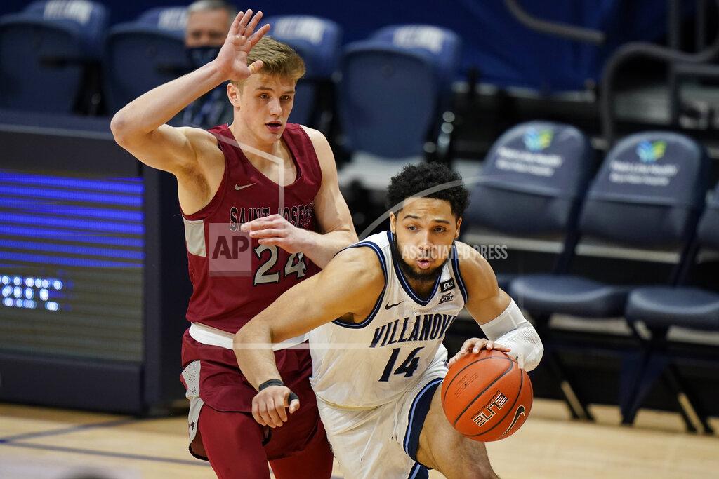Matt Slocum Villanova's Caleb Daniels (14) dribbles past Saint Joseph's Jack Forrest (24) during the first half of an NCAA college basketball game, Saturday, Dec. 19, 2020, in Villanova, Pa. (AP Photo/Matt Slocum)