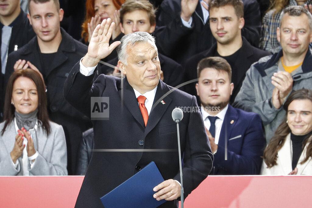Laszlo Balogh Hungarian Prime Minister Viktor Orban waves to supporters during celebration the 65th anniversary of the 1956 Hungarian revolution, in Budapest, Hungary, Saturday, Oct. 23, 2021. Thousands of supporters of Prime Minister Viktor Orban, who is expected to deliver a speech marking the 65th anniversary of the 1956 Hungarian revolution, march in Budapest, Hungary to demonstrate loyalty to his right-wing government. (AP Photo/Laszlo Balogh)