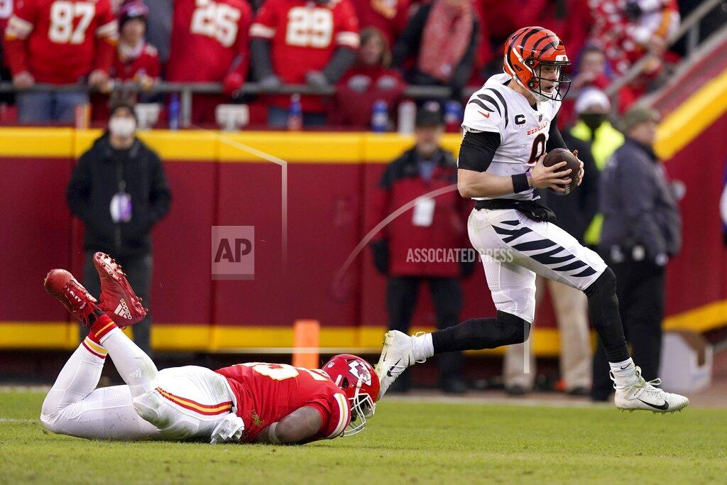 Charlie Riedel Cincinnati Bengals quarterback Joe Burrow (9) runs from Kansas City Chiefs defensive end Chris Jones, left, during the second half of the AFC championship NFL football game, Sunday, Jan. 30, 2022, in Kansas City, Mo. (AP Photo/Charlie Riedel)