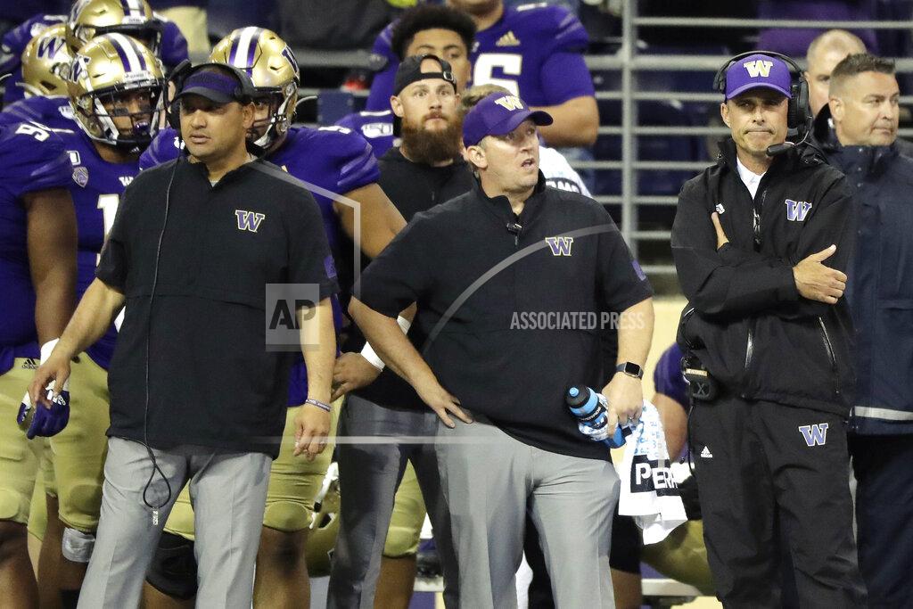 Ted S. Warren Washington head coach Chris Petersen, right, stands with other members of his staff late in the second half of an NCAA college football game in the early hours of Sunday, Sept. 8, 2019, in Seattle. California won 20-19. (AP Photo/Ted S. Warren)