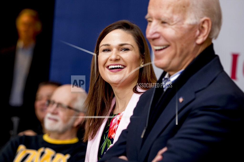 Andrew Harnik FILE - In this Friday, Jan. 3 2020 file photo Democratic presidential candidate Joe Biden, right, and Rep. Abby Finkenauer, D-Iowa, center, smile during a campaign rally at the University of Dubuque, in Dubuque, Iowa. (AP Photo/Andrew Harnik)