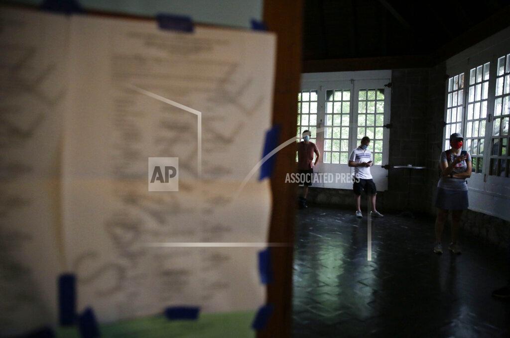 Brynn Anderson People wait in line to vote in the Georgia's primary election at Park Tavern on Tuesday, June 9, 2020, in Atlanta. (AP Photo/Brynn Anderson)