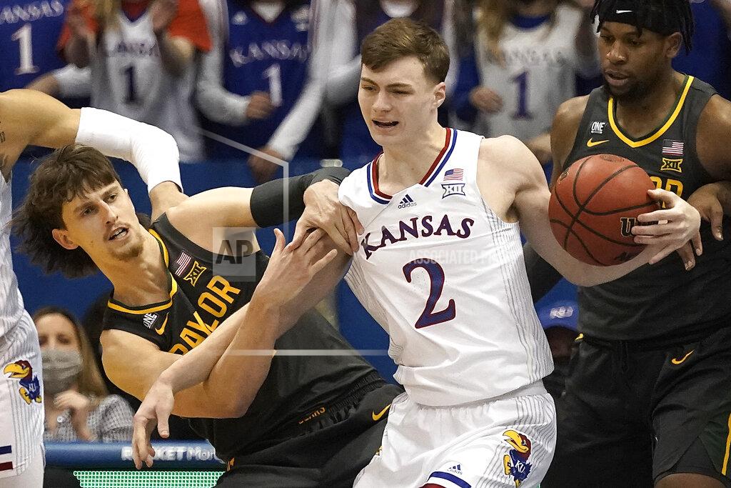 Charlie Riedel Kansas guard Christian Braun (2) beats Baylor guard Matthew Mayer, left, to a rebound during the first half of an NCAA college basketball game Saturday, Feb. 5, 2022, in Lawrence, Kan. (AP Photo/Charlie Riedel)