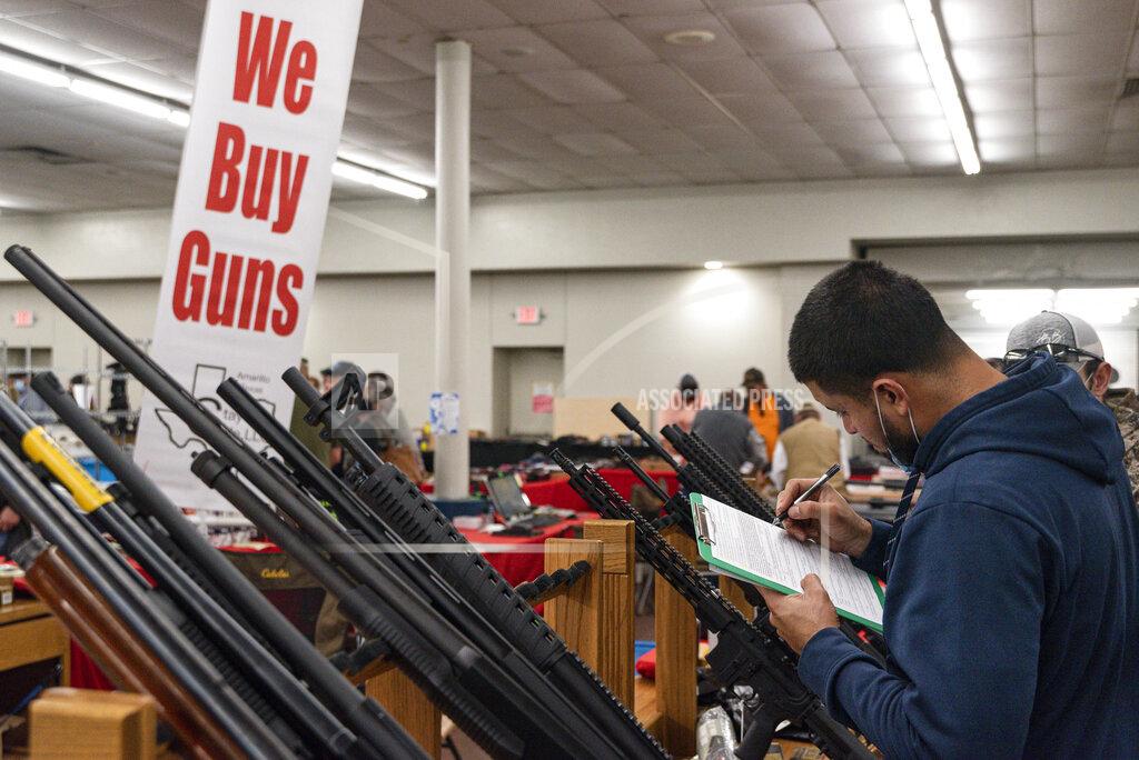 Eli Hartman FILE - Ivan Gonzalez fills out paperwork while purchasing a gun at the Silver Spur Gun and Blade Show, Saturday, Jan. 23, 2021, in Odessa, Texas. After a year of pandemic lockdowns, mass shootings are back, but the guns never went away. As the U.S. inches toward a post-pandemic future, guns are arguably more present in the American psyche and more deeply embedded in American discourse than ever before. The past year's anxiety and loss fueled a rise in gun ownership across political and socio-economic lines. (Eli Hartman/Odessa American via AP, File)