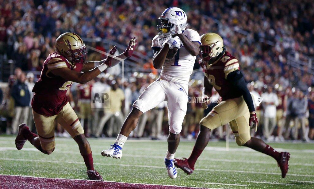 Michael Dwyer Kansas running back Pooka Williams Jr. (1) scores against Boston College defensive back Mehdi El Attrach (25) and linebacker John Lamot (28) during the second half of an NCAA college football game in Boston, Friday, Sept. 13, 2019. (AP Photo/Michael Dwyer)