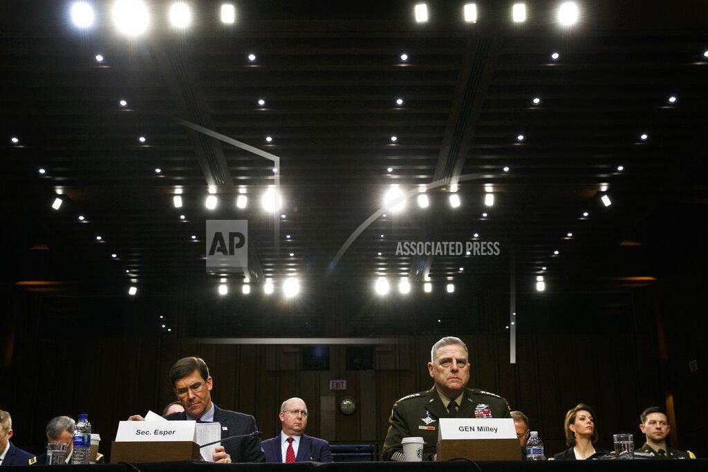 FILE - In this March 4, 2020, file photo Defense Secretary Mark Esper, left, and Chairman of the Joint Chiefs of Staff Gen. Mark Milley, listen during a Senate Armed Services Committee on budget posture on Capitol Hill in Washington. Esper and Milley are going before Congress for the first time in months to face a long list of controversies, including their differences with President Donald Trump over the handling of protests near the White House last month during unrest triggered by the killing George Floyd in police hands. (AP Photo/Jacquelyn Martin, File)