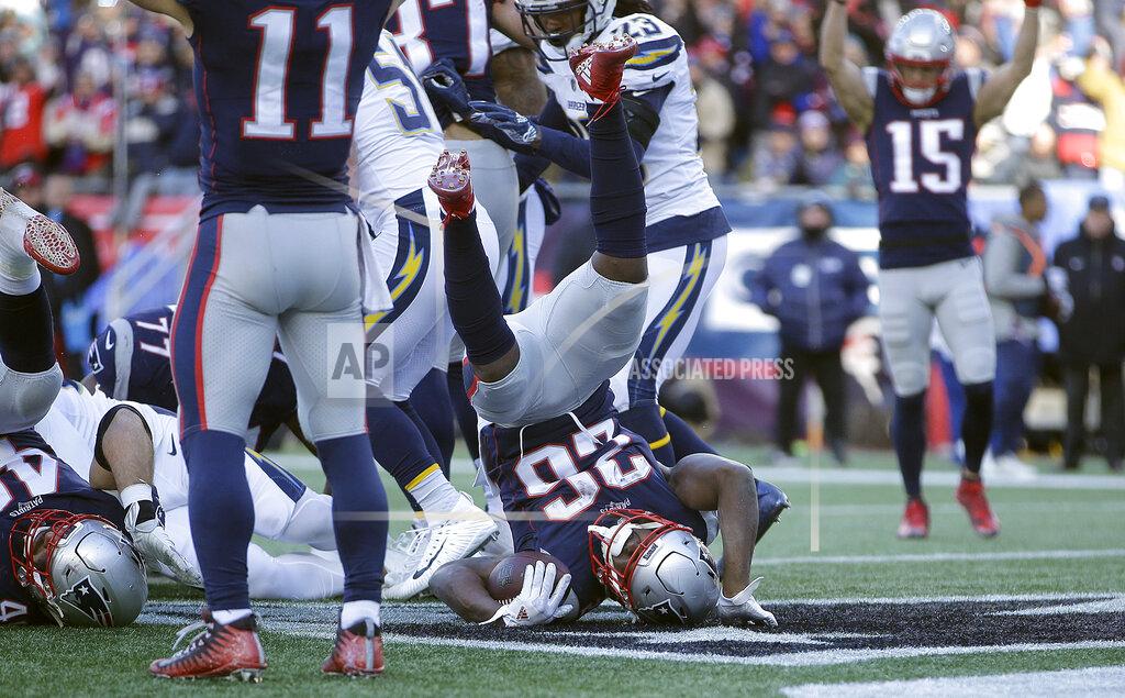 Steven Senne New England Patriots running back Sony Michel (26) tumbles into the end zone for his third touchdown against the Los Angeles Chargers during the first half of an NFL divisional playoff football game, Sunday, Jan. 13, 2019, in Foxborough, Mass. (AP Photo/Steven Senne)