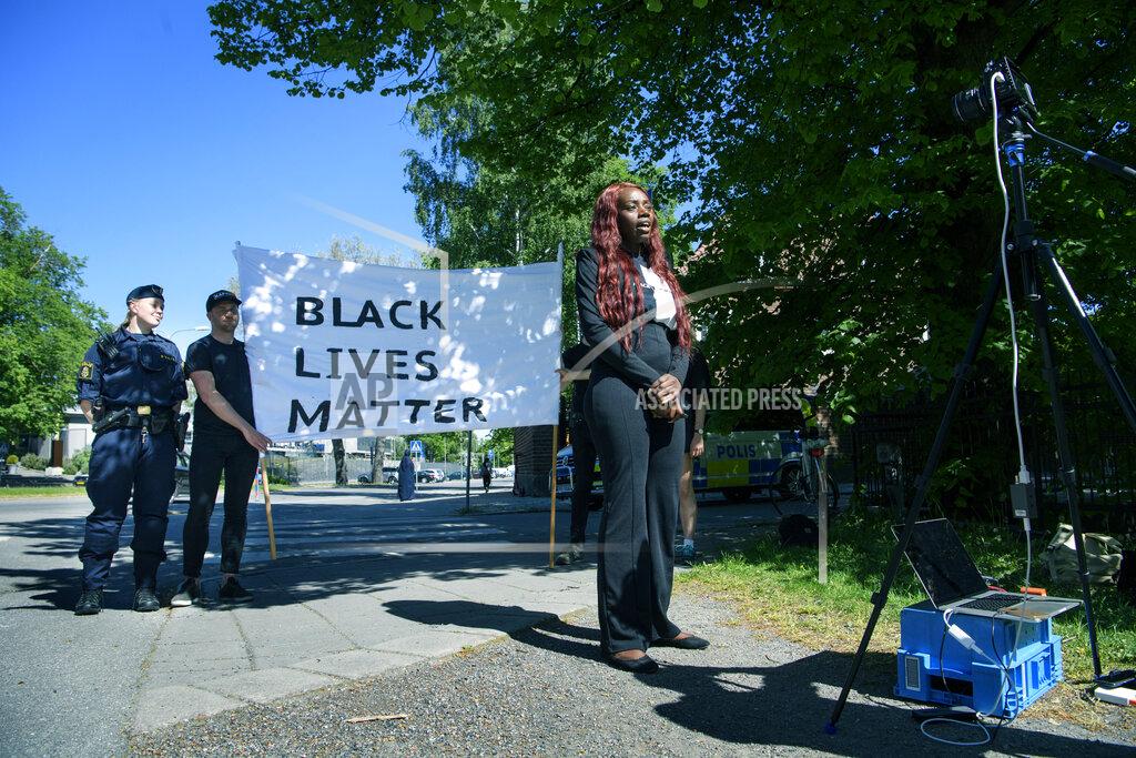 Jessica Gow Aysha Jones speaks during a digital demonstration to show solidarity with the protests in the United States in response of the death of George Floyd who died after being restrained by Minneapolis police officers on May 25 and to remember other black victims of police violence outside the US embassy in Stockholm, Sweden, Tuesday, June 2, 2020. (Jessica Gow/TT News Agency via AP)