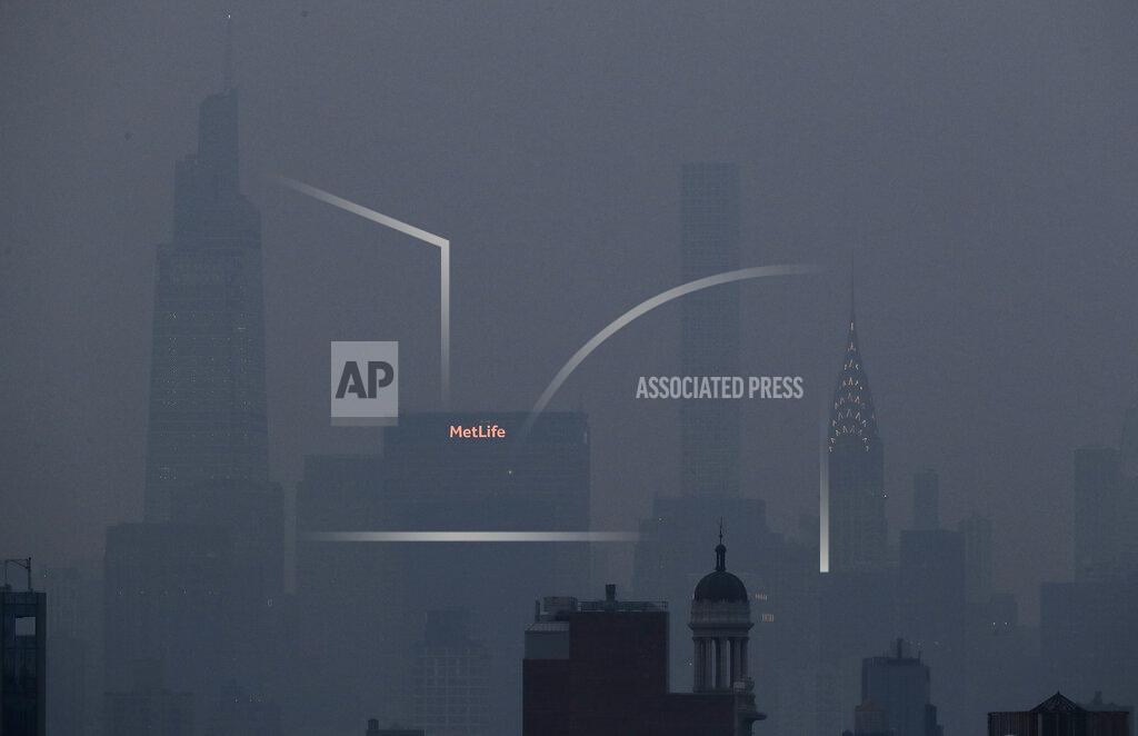 Julie Jacobson The Met Life and Chrysler buildings glow through a thick haze hanging over Manhattan, Tuesday, July 20, 2021, in New York. Wildfires in the American West, including one burning in Oregon that's currently the largest in the U.S., are creating hazy skies as far away as New York as the massive infernos spew smoke and ash into the air in columns up to six miles high. (AP Photo/Julie Jacobson)