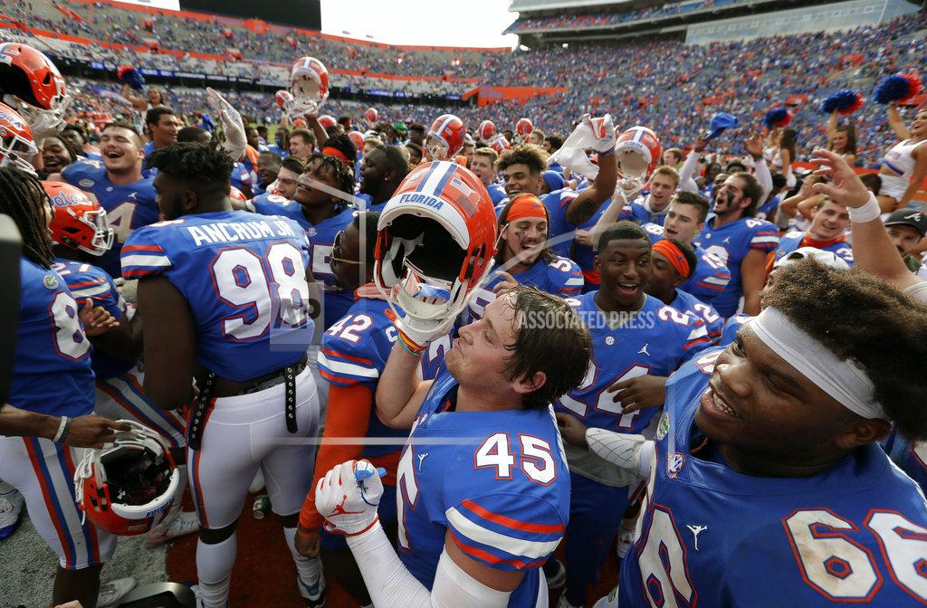 John Raoux Florida players celebrate in front of fans after defeating South Carolina in an NCAA college football game, Saturday, Nov. 10, 2018, in Gainesville, Fla. (AP Photo/John Raoux)