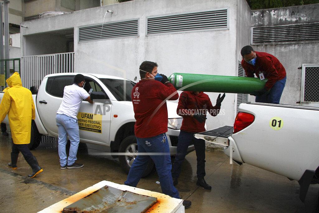 Edmar Barros Amazonas Federal University's workers carry empty oxygen tanks at the Getulio Vargas Hospital amid the new coronavirus pandemic, Manaus, Brazil, Thursday, Jan. 14, 2021. Scores of COVID-19 patients in the Amazon rainforest's biggest city will be transferred out of state as the local health system collapses and dwindling stocks of oxygen tanks begin to falter. (AP Photos/Edmar Barros)