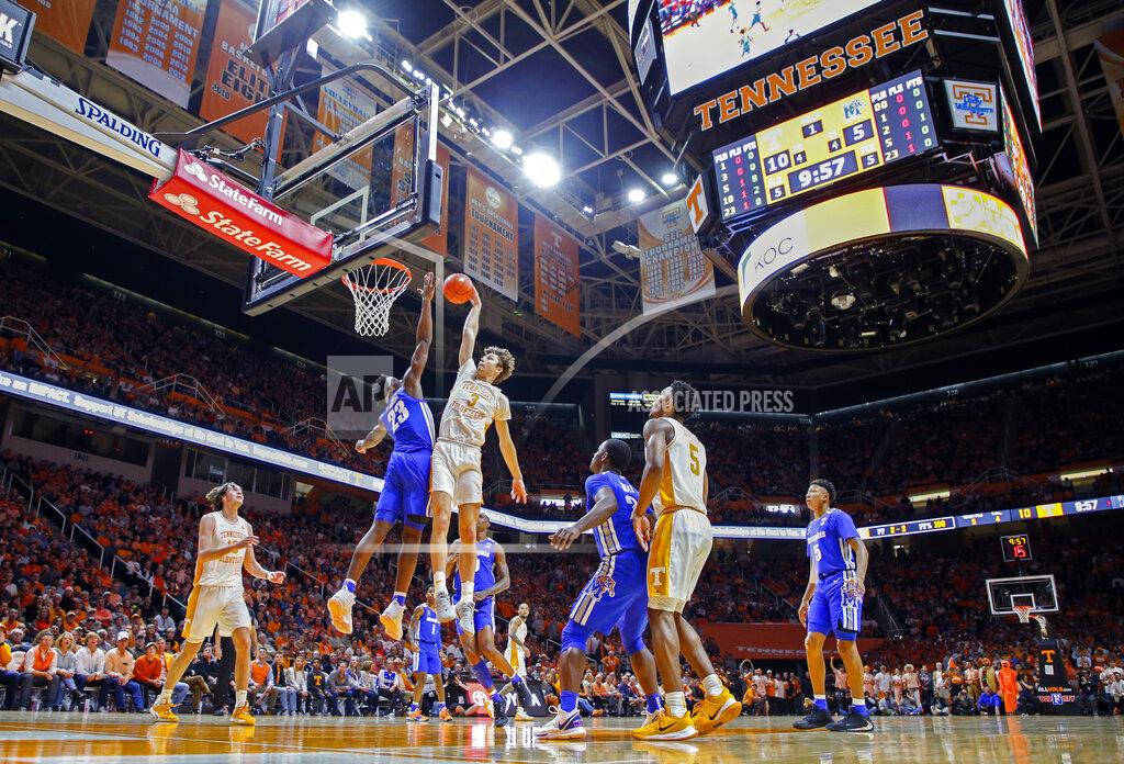 Wade Payne Tennessee forward Drew Pember (3) dunks the ball over Memphis center Malcolm Dandridge (23) during the first half of an NCAA college basketball game Saturday, Dec. 14, 2019, in Knoxville, Tenn. (AP Photo/Wade Payne)