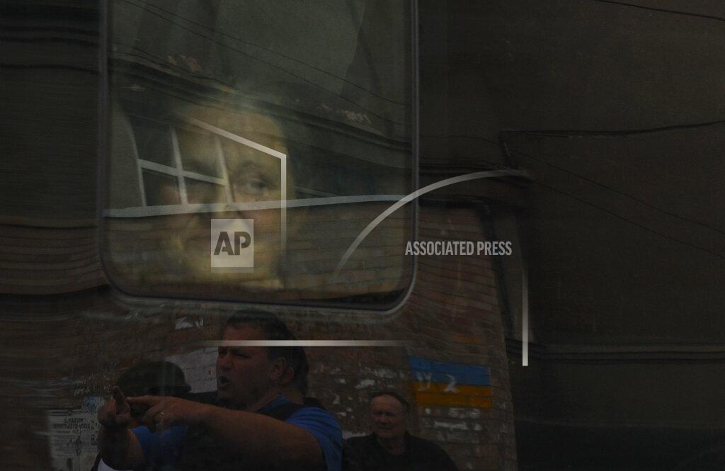 Andriy Andriyenko An elderly Ukrainian woman sits in the bus during an evacuation of civilians in Soledar, Donetsk region, Ukraine, Tuesday, May 24, 2022. (AP Photo/Andriy Andriyenko)