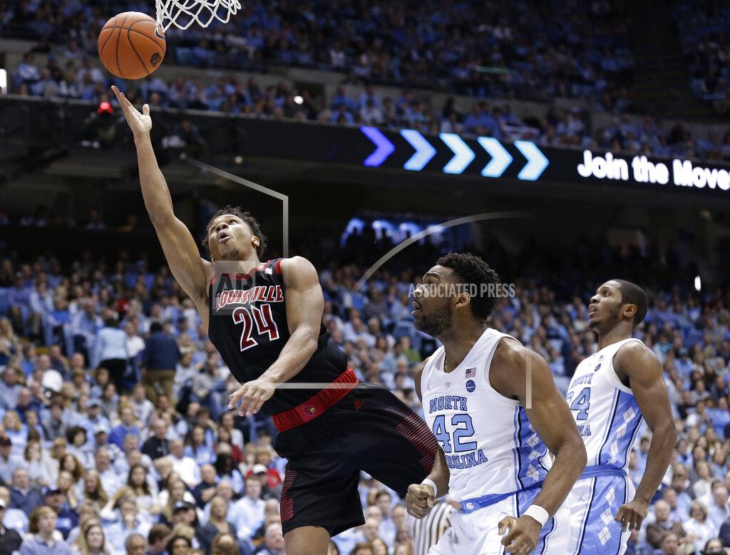 Gerry Broome Louisville's Dwayne Sutton (24) drives for a layup while North Carolina's Brandon Huffman (42) and Kenny Williams defend during the second half of an NCAA college basketball game in Chapel Hill, N.C., Saturday, Jan. 12, 2019. Louisville won 83-62. (AP Photo/Gerry Broome)