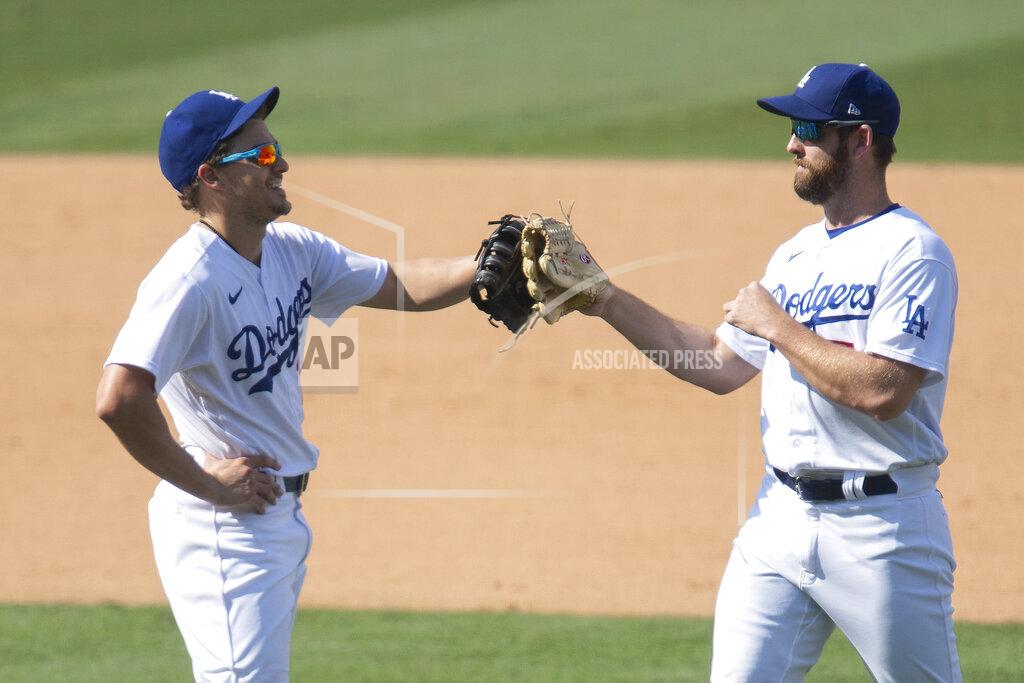 Kyusung Gong Los Angeles Dodgers first baseman Enrique Hernandez, left, and right fielder Adam Kolarek celebrate their win over the Los Angeles Angels in a baseball game in Los Angeles, Sunday, Sept. 27, 2020. (AP Photo/Kyusung Gong)