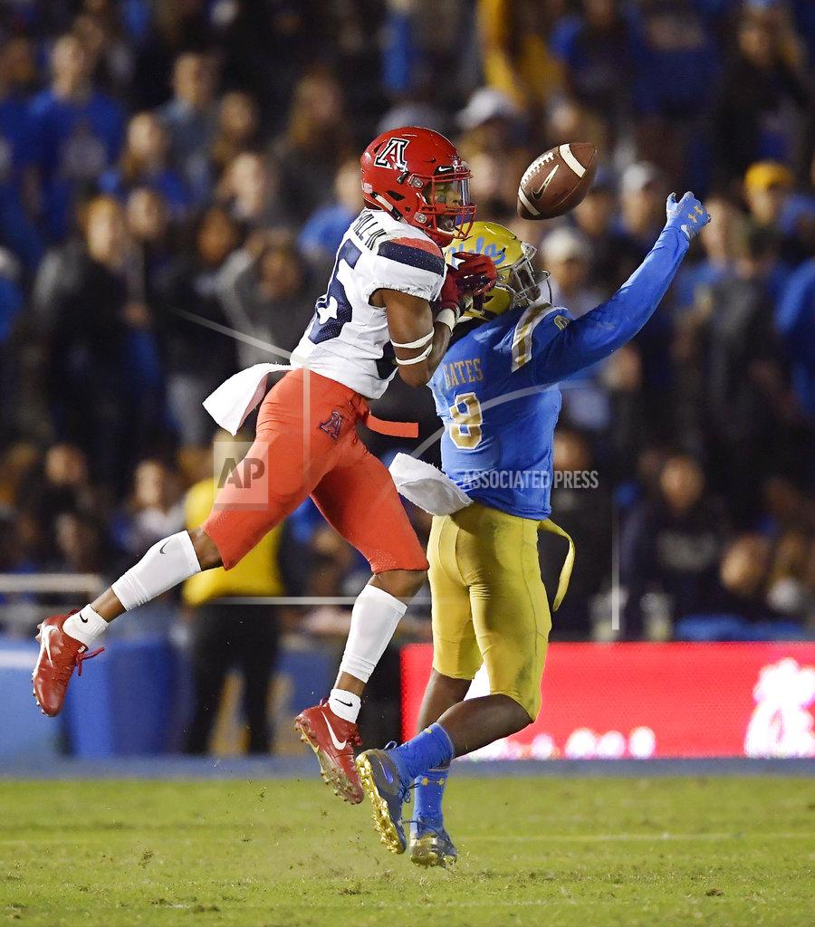 Mark J. Terrill UCLA defensive back Elijah Gates, right, intercepts a pass intended for Arizona wide receiver Stanley Berryhill III during the second half of an NCAA college football game Saturday, Oct. 20, 2018, in Pasadena, Calif. UCLA won 31-30. (AP Photo/Mark J. Terrill)