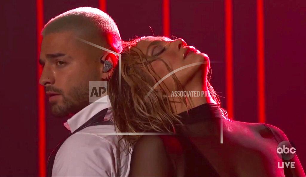 Uncredited In this screen shot provided by ABC on Sunday, Nov. 22, 2020, Mauma, left, and Jennifer Lopez perform at the American Music Awards at the Microsoft Theater in Los Angeles. (ABC via AP)