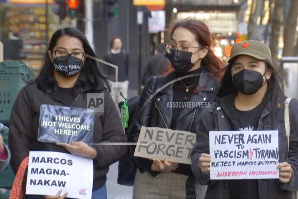 Uncredited In this image made from video, members of Australia’s Filipino community protest outside an apartment, Tuesday, May 17, 2022, in Melbourne, Australia, where the Philippines' presumptive next president, Ferdinand Marcos Jr., was reportedly visiting his son. (Australian Broadcasting Corp. via AP)