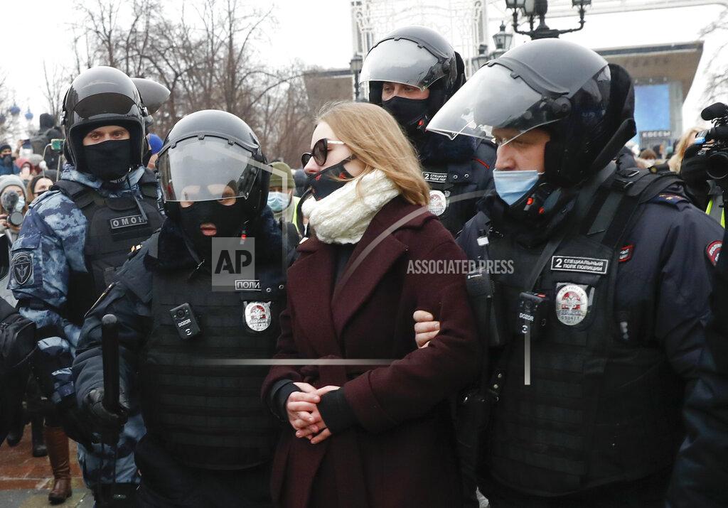 Pavel Golovkin Police detain a woman during a protest against the jailing of opposition leader Alexei Navalny in Moscow, Russia, Saturday, Jan. 23, 2021. Russian police are arresting protesters demanding the release of top Russian opposition leader Alexei Navalny at demonstrations in the country's east and larger unsanctioned rallies are expected later Saturday in Moscow and other major cities. (AP Photo/Pavel Golovkin)