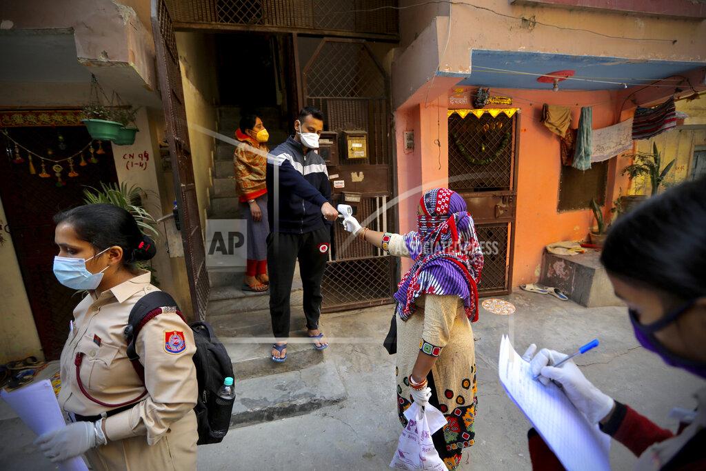 Manish Swarup Health workers conduct a door to door survey to assess the COVID-19 situation in New Delhi, India, Monday, Nov. 23, 2020. India has more than 9 million cases of coronavirus, second behind the United States. (AP Photo/Manish Swarup)